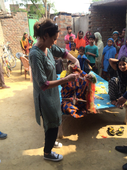 Thought you would like to see this this beautiful picture of our women spinning our yarns.