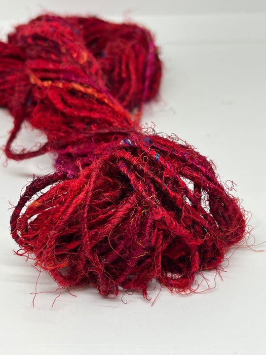 Sari silk yarn, Ruby Red. Sustainable waste silk.