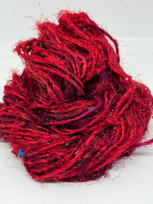 Sari silk yarn, Ruby Red. Sustainable waste silk.