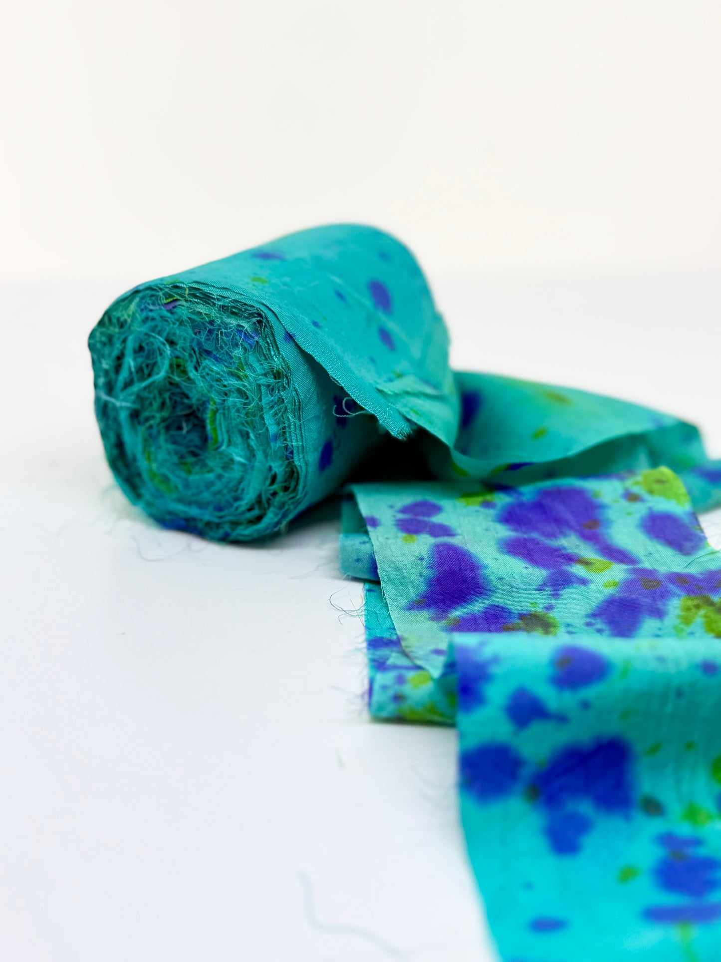 Sari silk fabric rolls hand spray dyed. Blue Reef