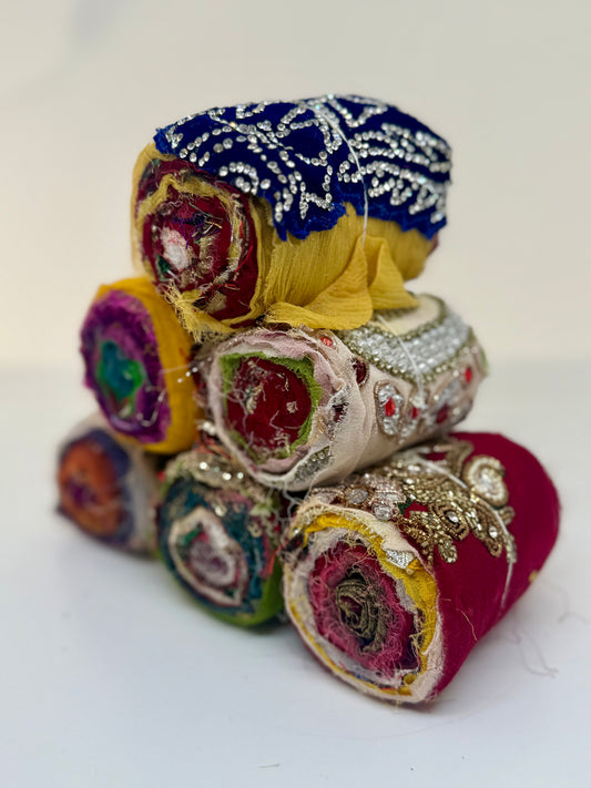 Embellished sari silk fabric rolls.
