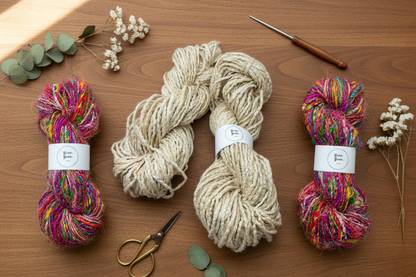 cream silk yarn sitting with two muclticoloured yarn